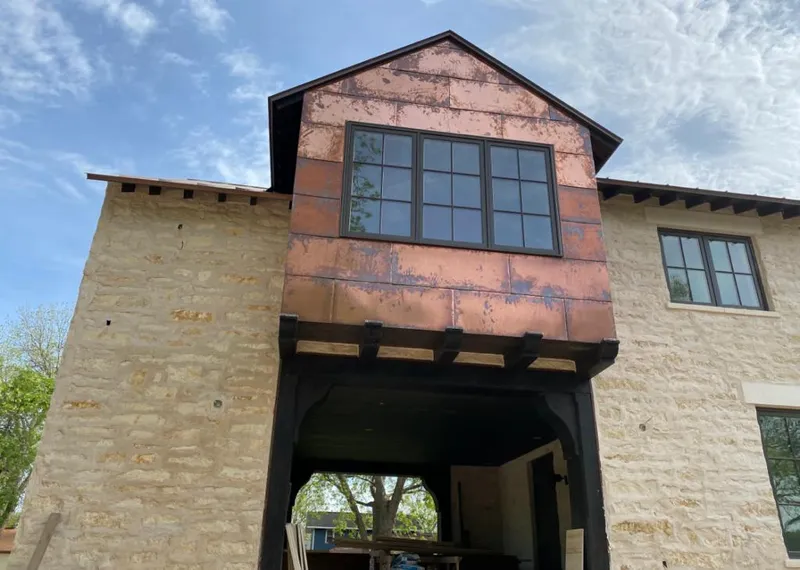 Copper metal panel facade on a stone building for Skylight Installation in Brookshire