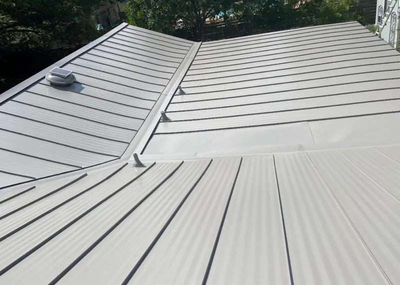 Solar attic fan installed on a metal roof for Roof Ventilation in Brookshire